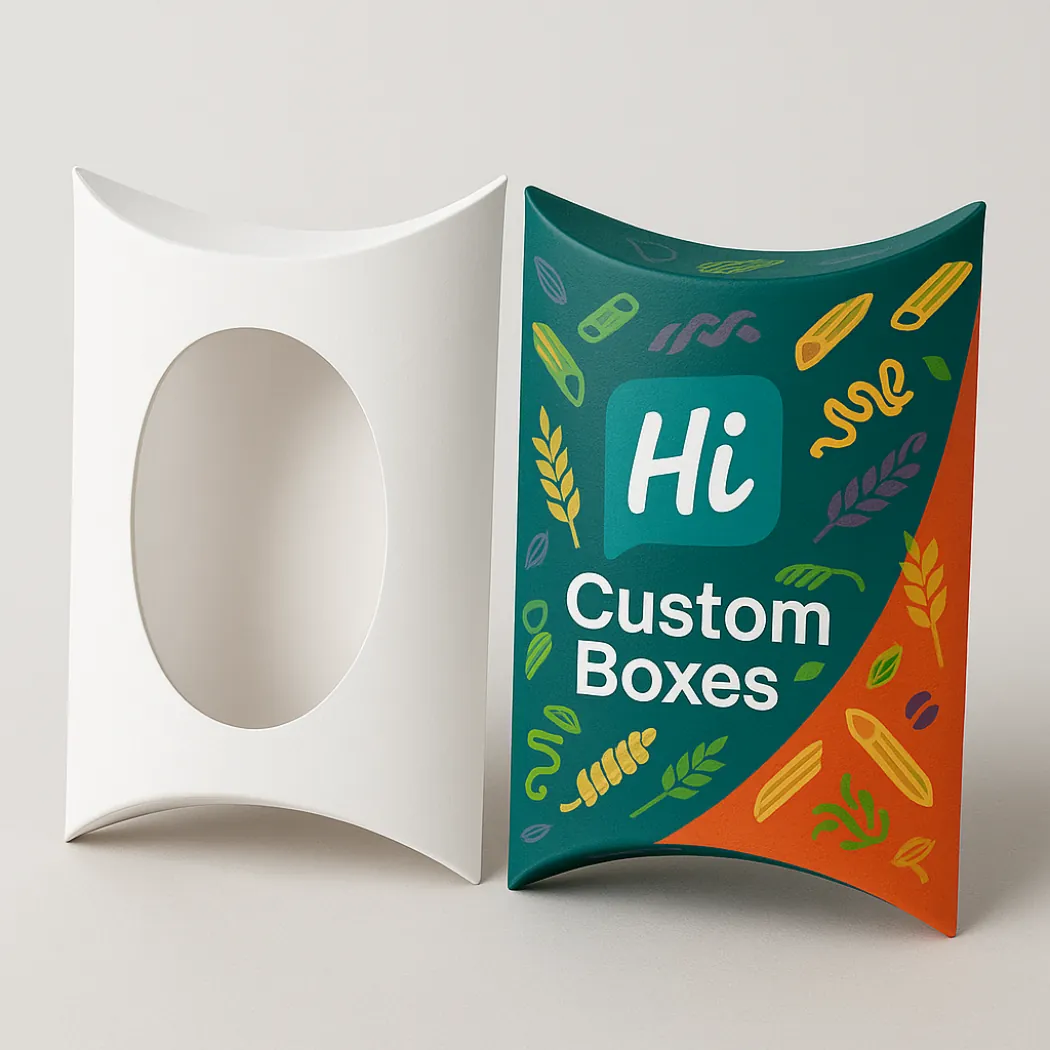 Two pillow-shaped pasta boxes- one white with an oval window and one teal with orange accents- class=